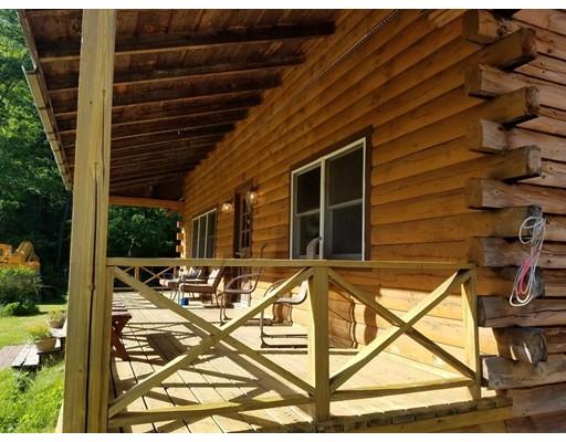 74 Watatic Mountain Road Ashby, MA 01431 - Photo 6 of 35 a view of a patio with table and chairs with wooden floor and fence