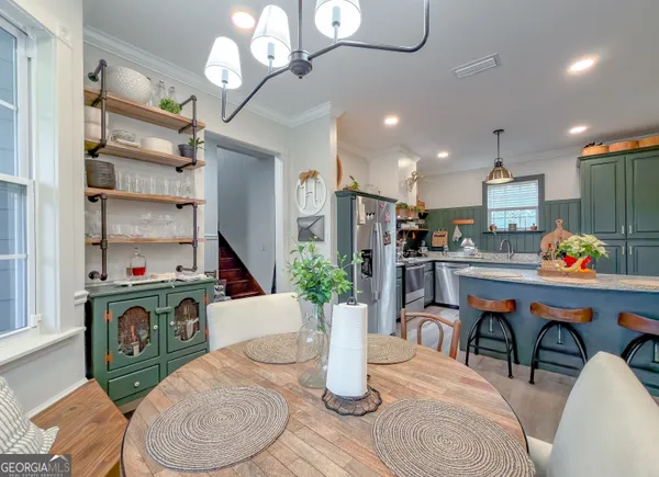 a living room with furniture and kitchen view