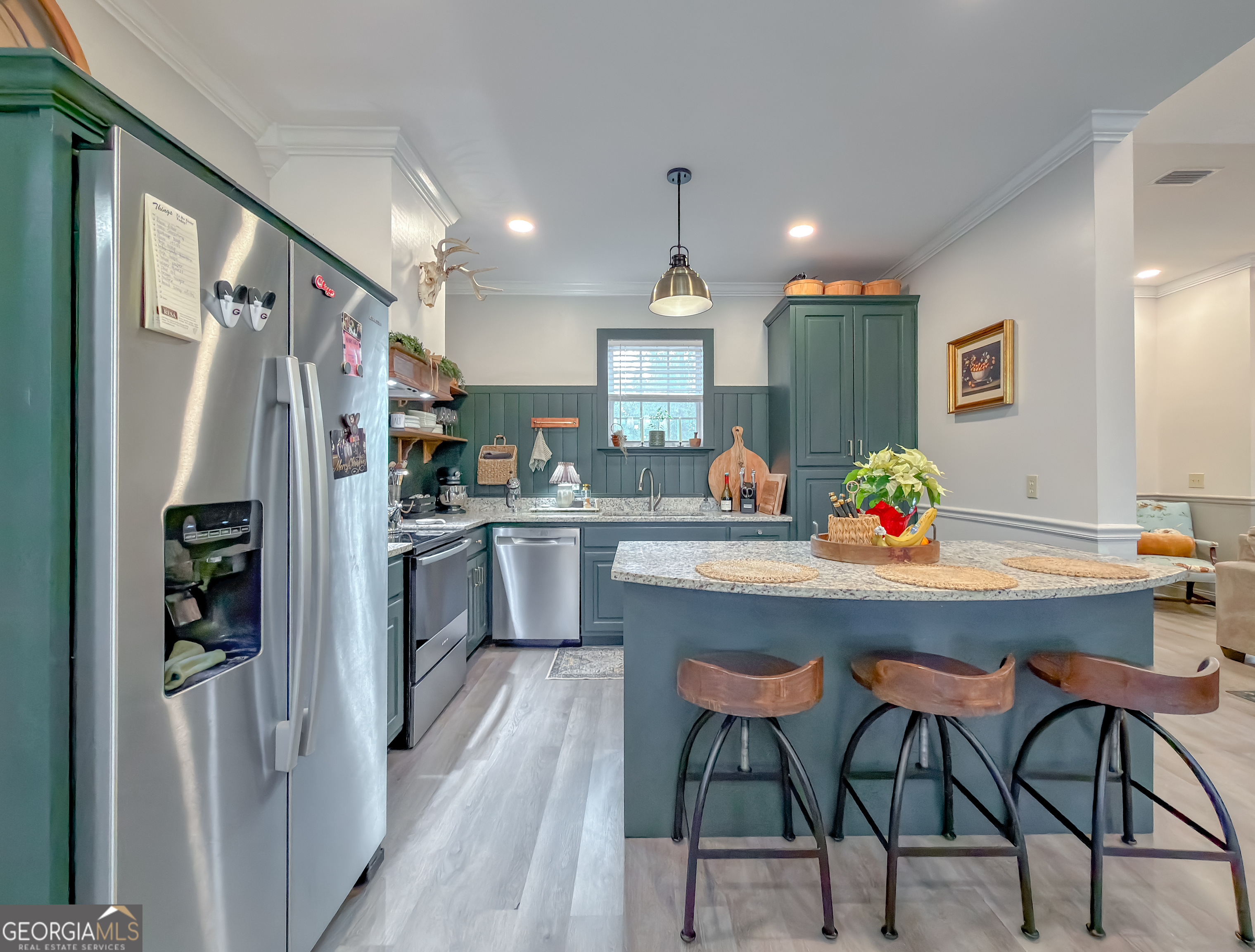 100 Robin Lane Bainbridge, GA 39819 - Photo 18 of 74 a kitchen with stainless steel appliances granite countertop a dining table chairs refrigerator and sink