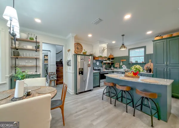 a large kitchen with lots of counter space sink and stove