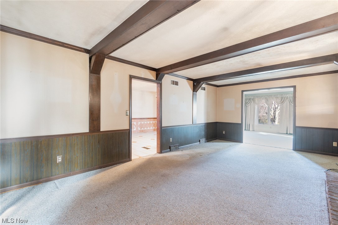 6038 Tippecanoe Road Canfield, OH 44406 - Photo 11 of 34 Unfurnished living room with beamed ceiling and light colored carpet