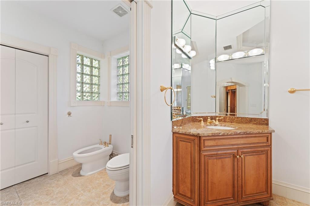 7126 Mill Run Road Naples, FL 34109 - Photo 16 of 49 Bathroom featuring vanity, toilet, and a bidet