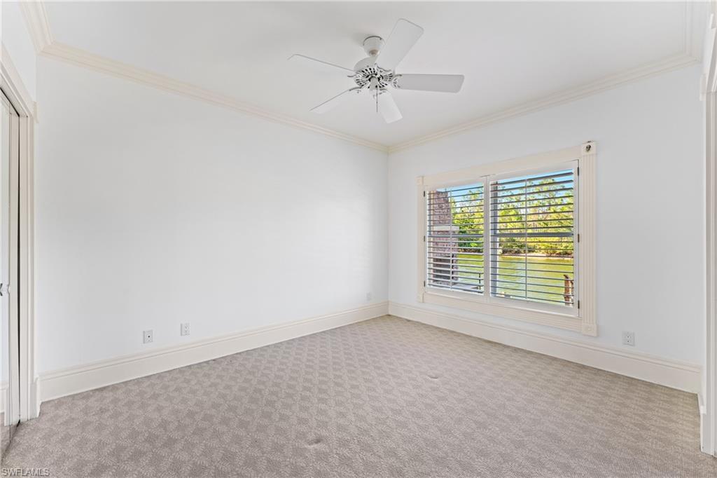 7126 Mill Run Road Naples, FL 34109 - Photo 24 of 49 Carpeted empty room with ceiling fan and crown molding