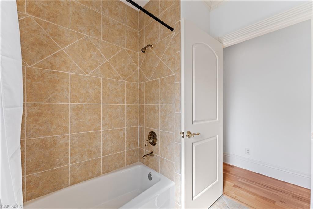 7126 Mill Run Road Naples, FL 34109 - Photo 28 of 49 Bathroom with shower / tub combo with curtain