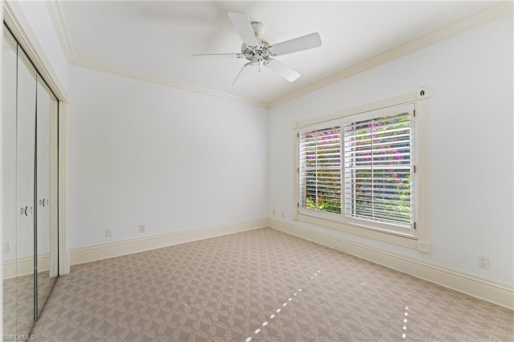 7126 Mill Run Road Naples, FL 34109 - Photo 30 of 49 Unfurnished bedroom with light carpet, a closet, ceiling fan, and ornamental molding