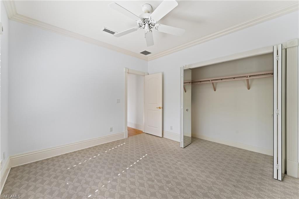 7126 Mill Run Road Naples, FL 34109 - Photo 31 of 49 Unfurnished bedroom featuring light carpet, a closet, ceiling fan, and ornamental molding