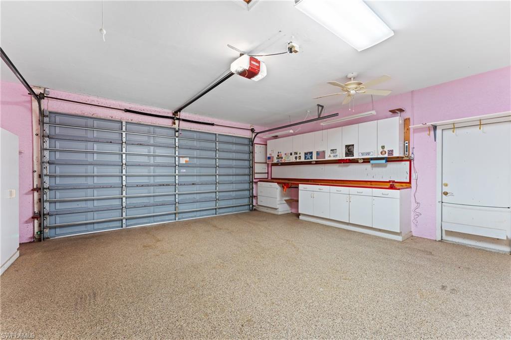 7126 Mill Run Road Naples, FL 34109 - Photo 33 of 49 Garage featuring ceiling fan and a garage door opener