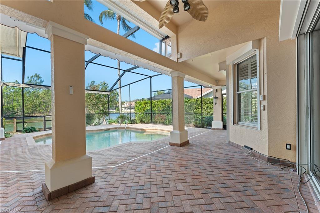 7126 Mill Run Road Naples, FL 34109 - Photo 34 of 49 View of pool featuring a lanai, ceiling fan, and a patio