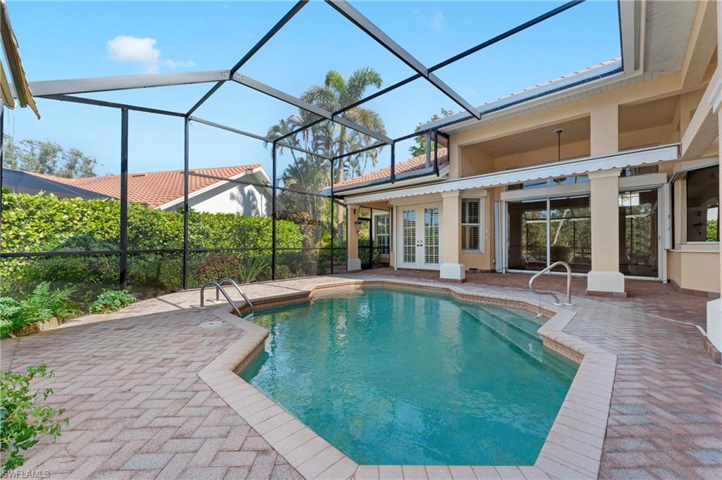 7126 Mill Run Road Naples, FL 34109 - Photo 35 of 49 View of pool with french doors, glass enclosure, and a patio area