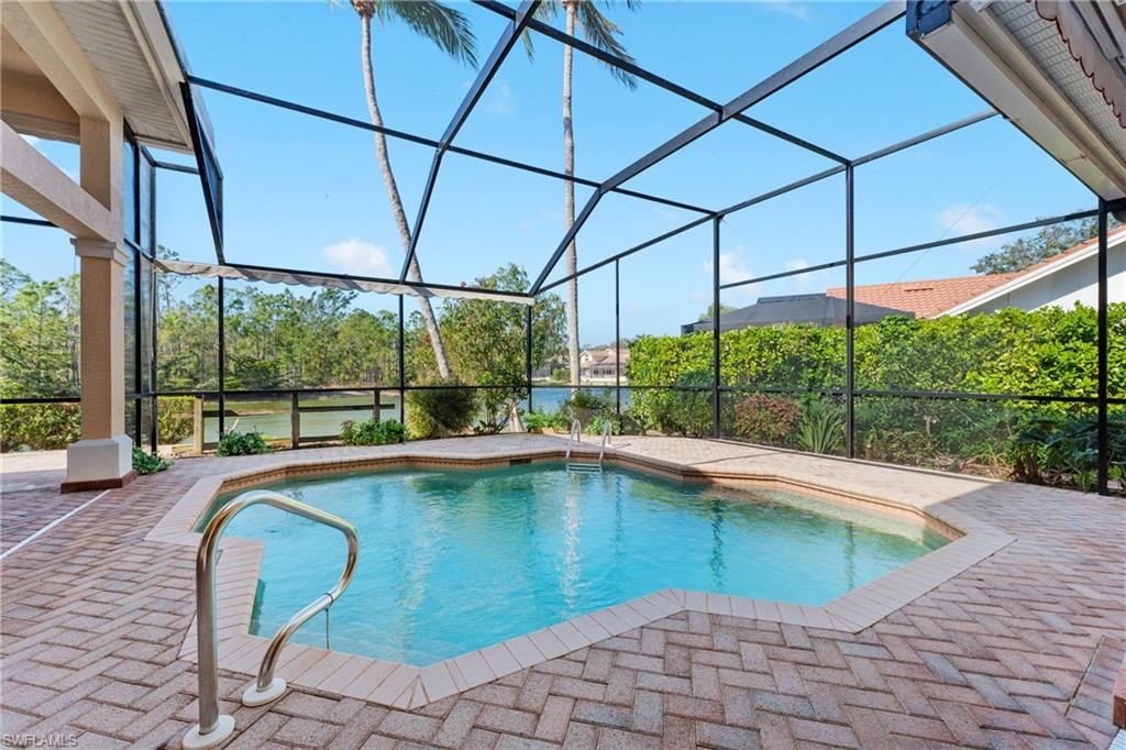 7126 Mill Run Road Naples, FL 34109 - Photo 36 of 49 View of swimming pool with glass enclosure and a patio