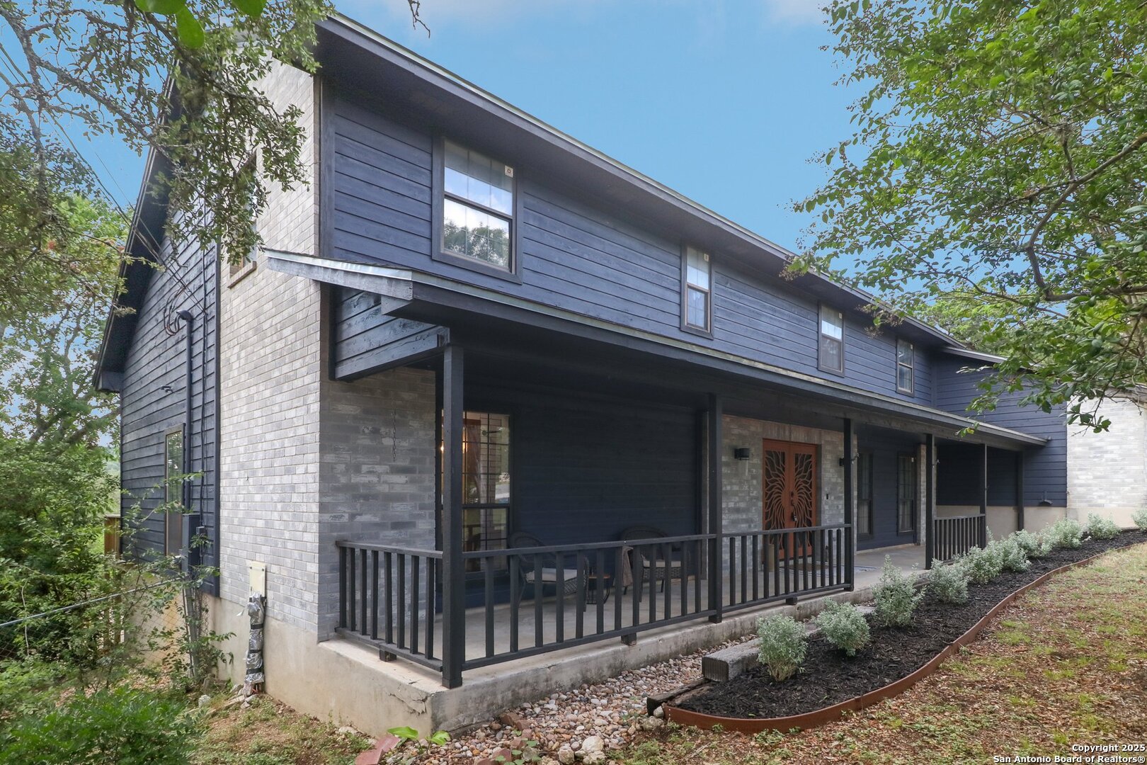 20211 County Road 174 Helotes, TX 78023 - Photo 12 of 45 a view of a house with a yard and potted plants