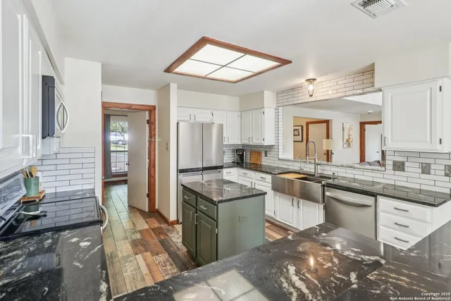 a kitchen with a sink stove and cabinets