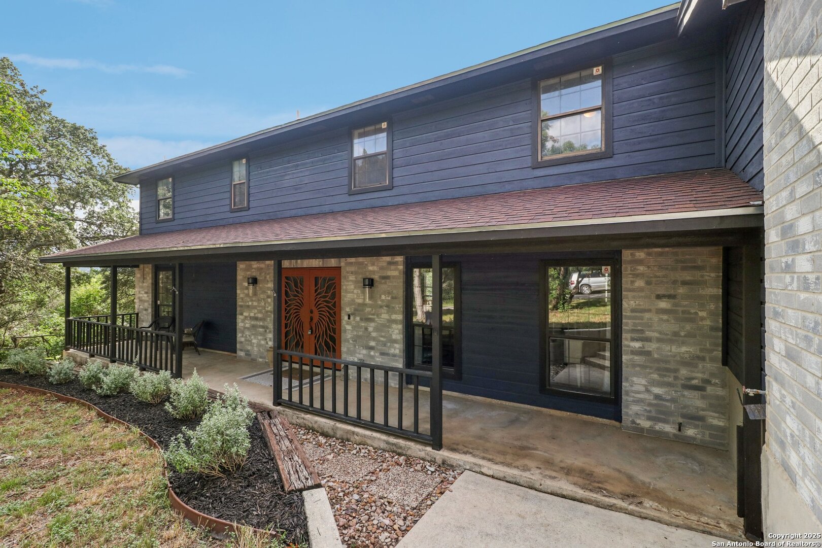 20211 County Road 174 Helotes, TX 78023 - Photo 2 of 45 front view of a brick house with a large window