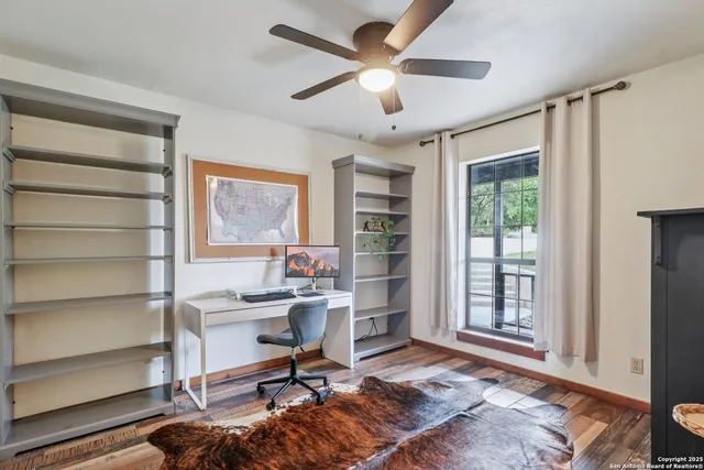 a view of a livingroom with workspace and a window