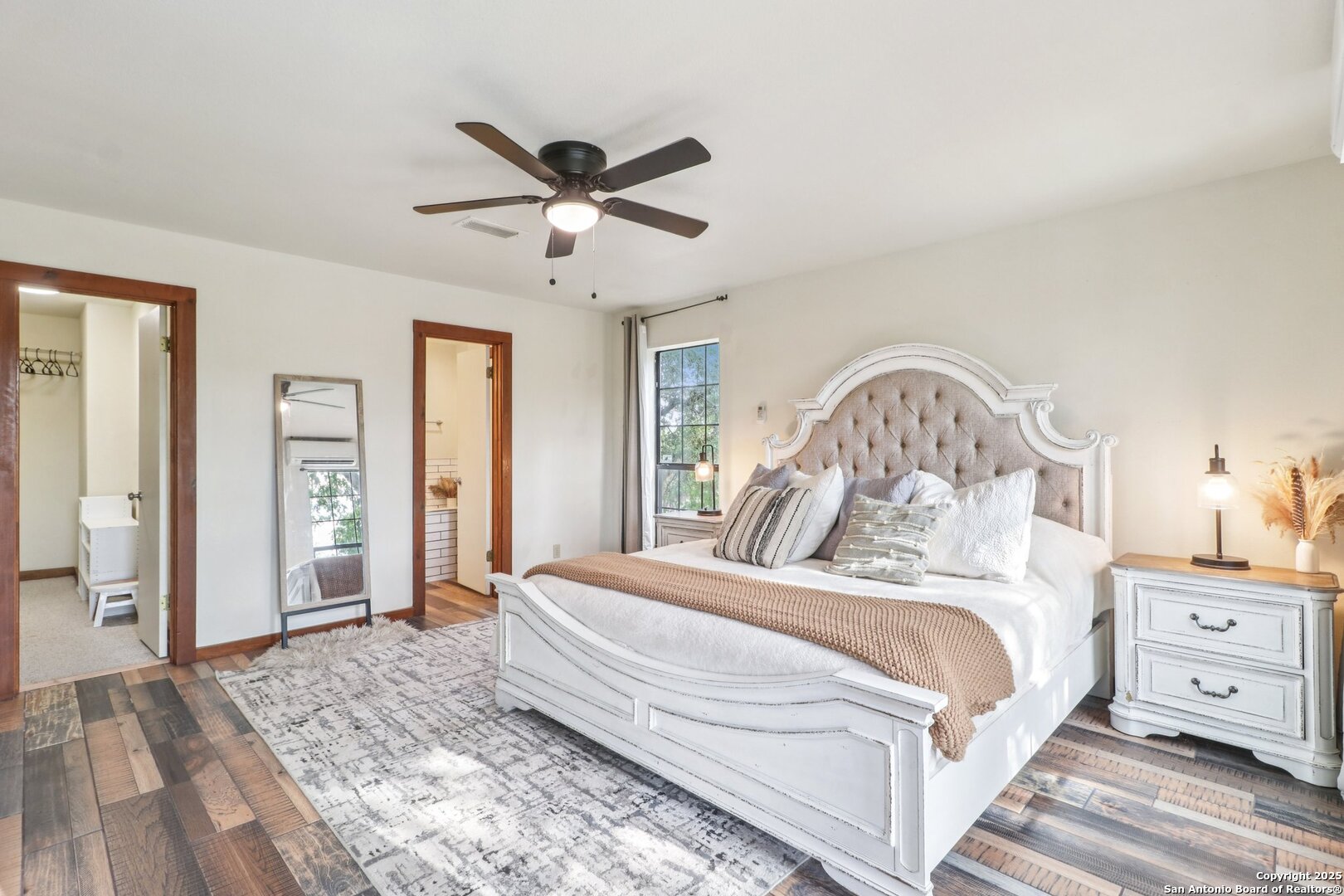 20211 County Road 174 Helotes, TX 78023 - Photo 24 of 45 a bedroom with a large bed and a chandelier