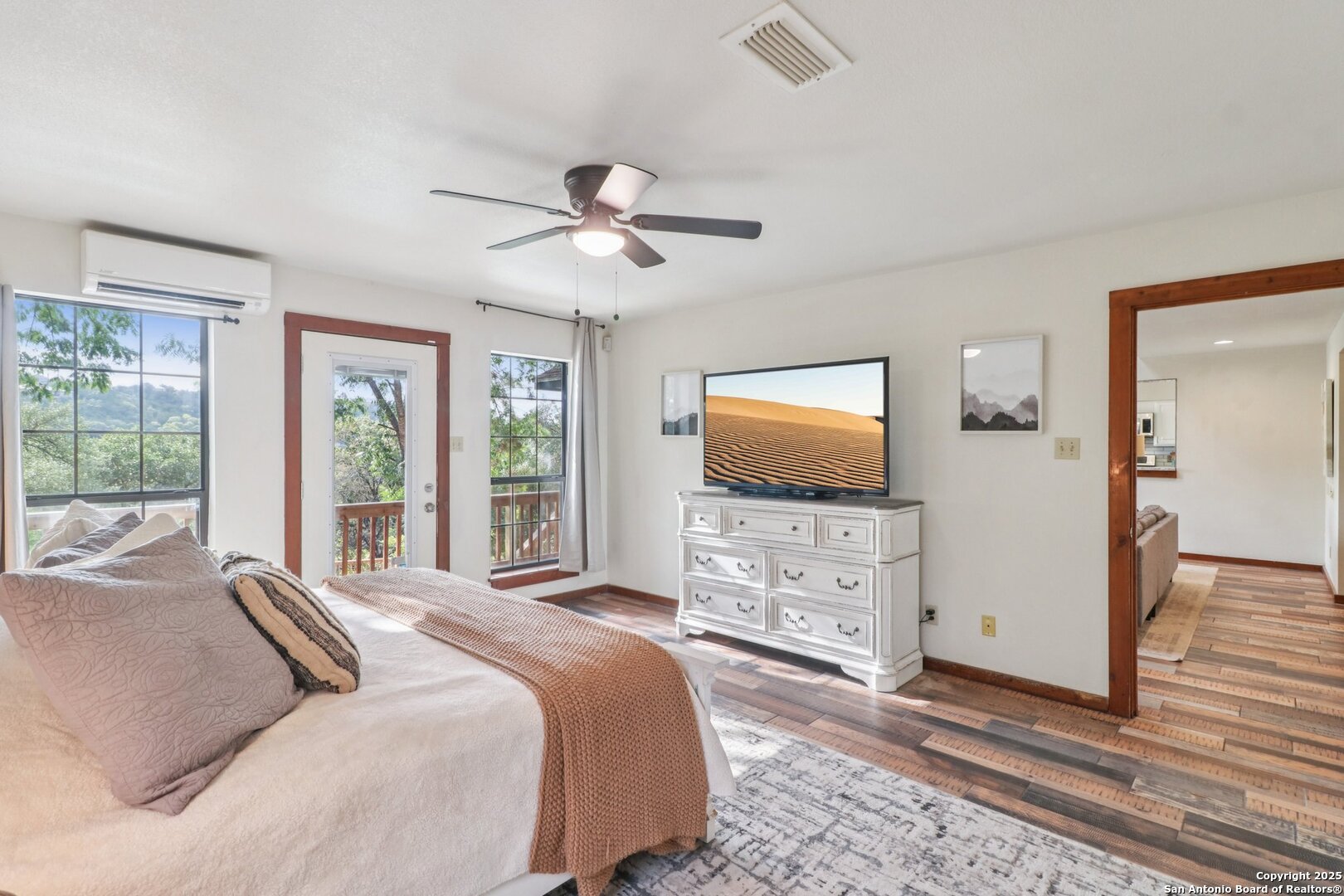 20211 County Road 174 Helotes, TX 78023 - Photo 25 of 45 a bedroom with a bed a window and a flat screen television