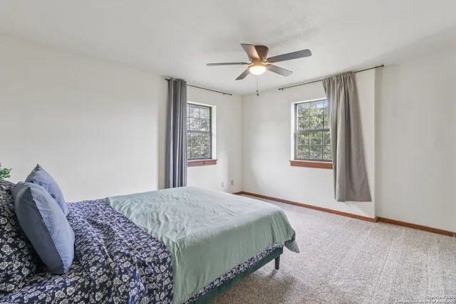 a bedroom with a large bed and a window