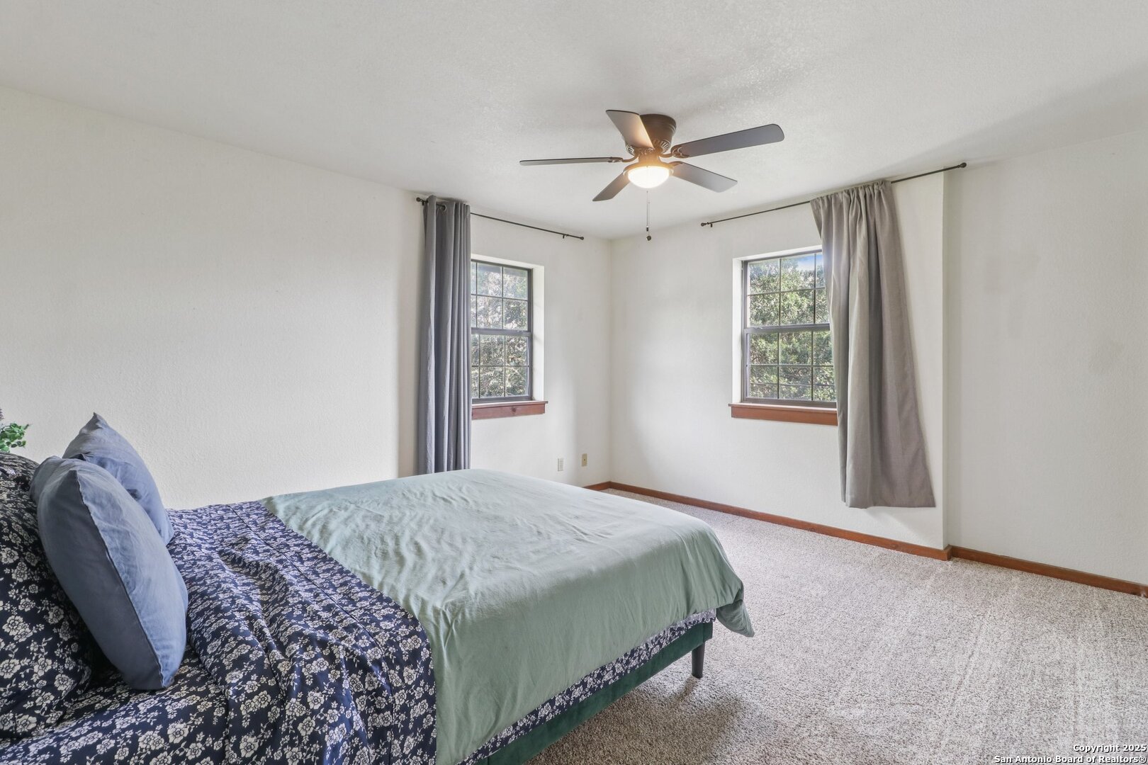 20211 County Road 174 Helotes, TX 78023 - Photo 36 of 45 a bedroom with a large bed and a window