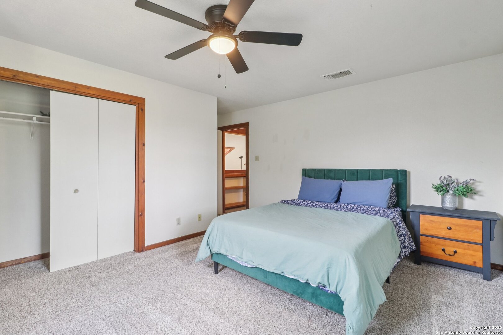 20211 County Road 174 Helotes, TX 78023 - Photo 37 of 45 a bedroom with a bed and a chandelier