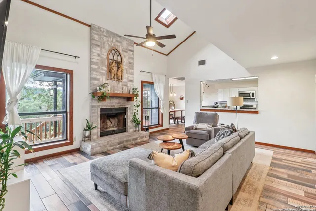 a living room with furniture fireplace and flat screen tv