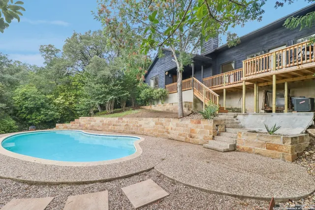 a view of a house with backyard and sitting area