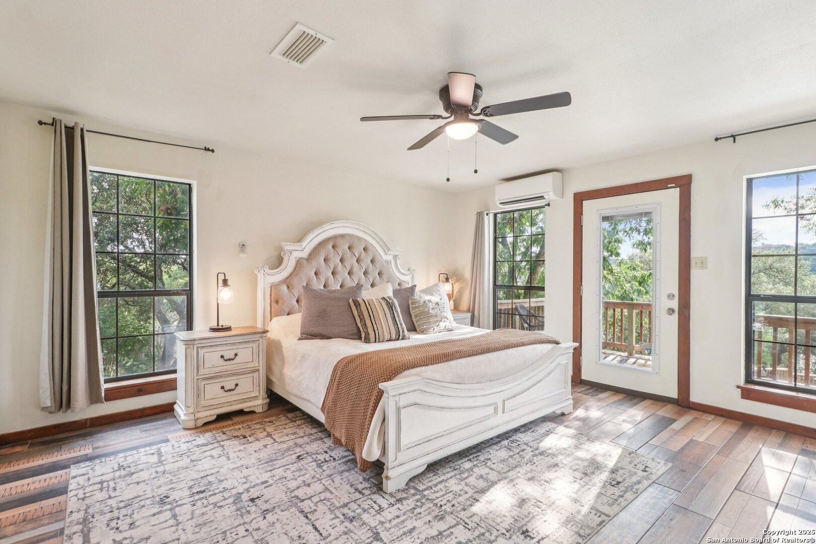 20211 County Road 174 Helotes, TX 78023 - Photo 6 of 45 a bedroom with a large bed and a window