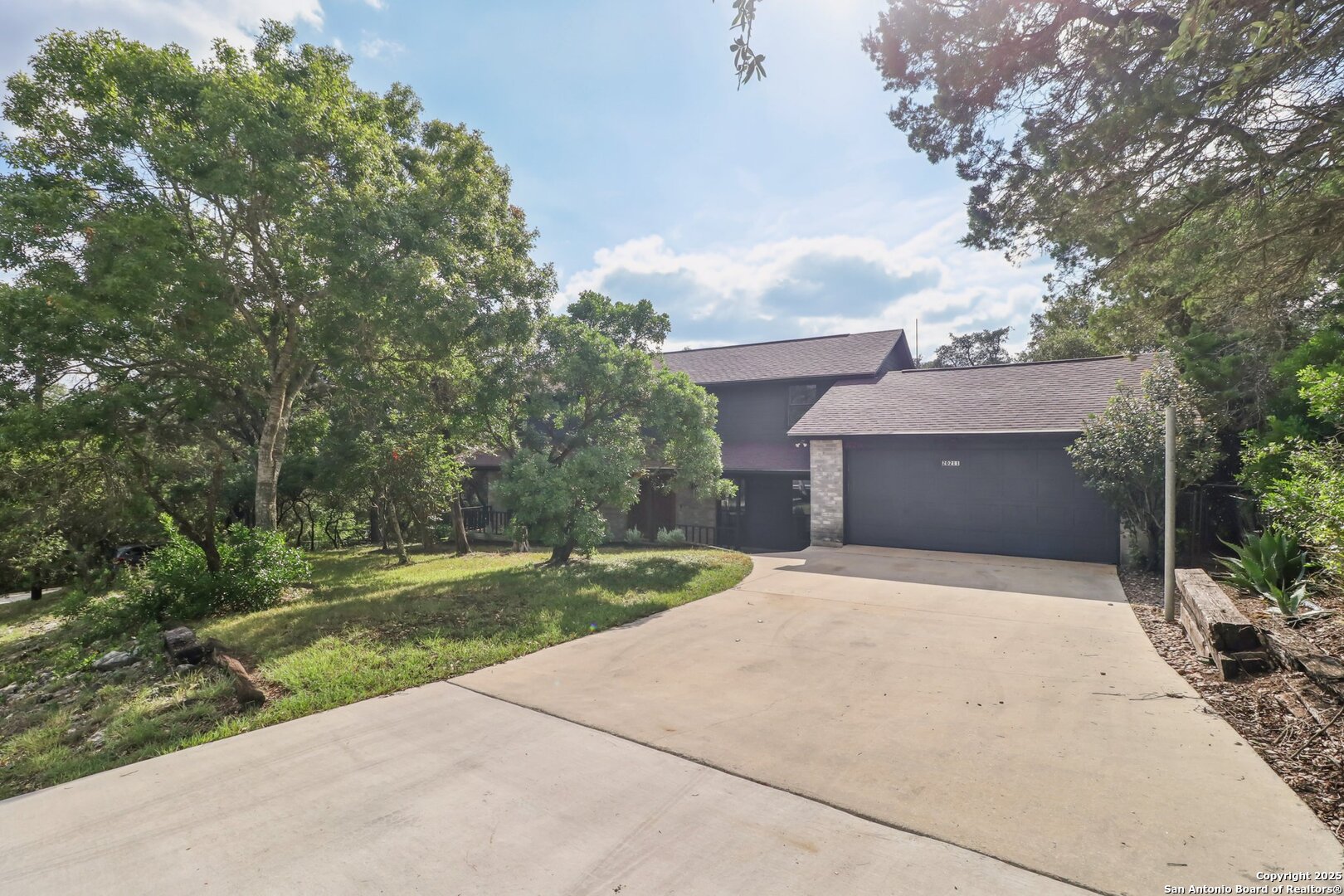 20211 County Road 174 Helotes, TX 78023 - Photo 9 of 45 a front view of a house with a yard and garage