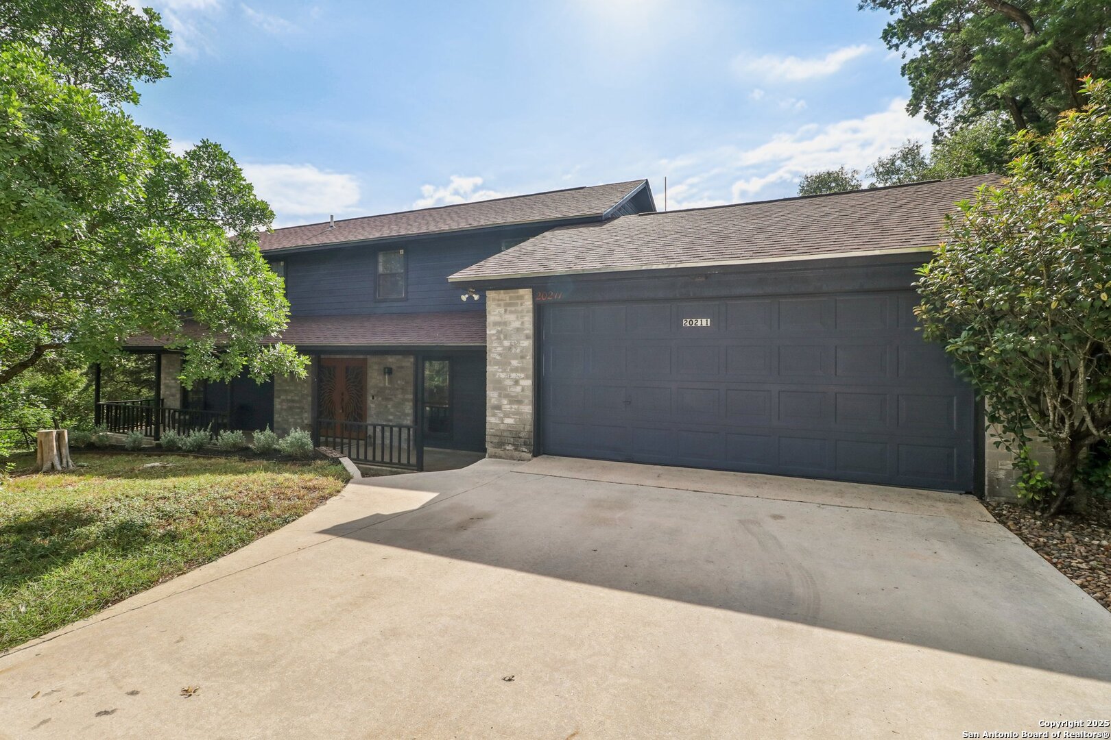 20211 County Road 174 Helotes, TX 78023 - Photo 10 of 45 a front view of a house with a yard and garage