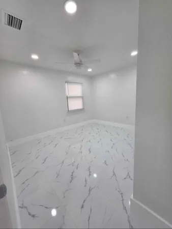 a bathroom with a double vanity sink toilet and shower