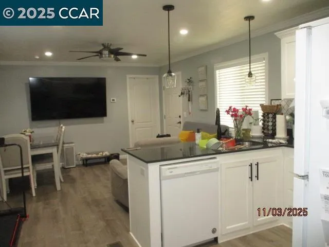 a kitchen with stainless steel appliances kitchen island granite countertop a sink and a cabinets