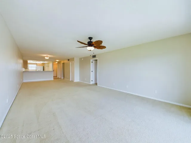 a view of a livingroom with a chandelier fan