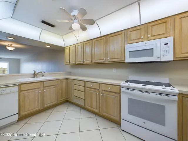 a kitchen with cabinets appliances cabinets and a sink