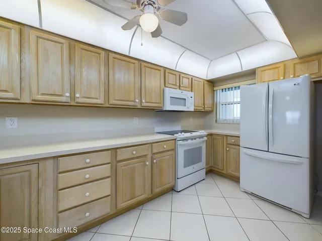 a kitchen with cabinets stainless steel appliances and a counter space