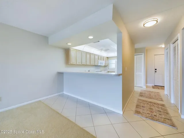a view of a kitchen with white cabinets