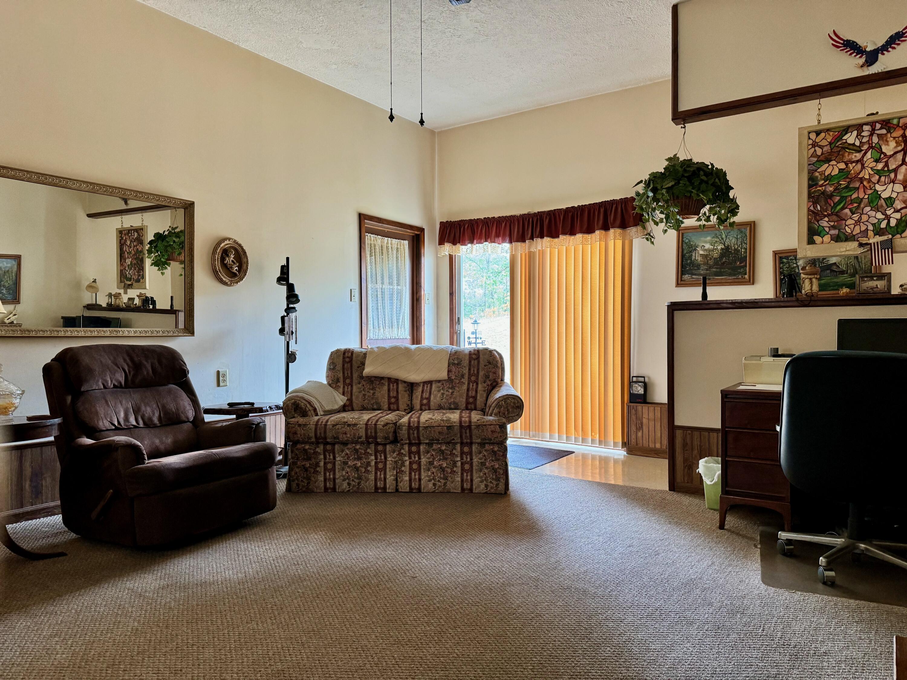 2720 South Toto Road North Judson, IN 46366 - Photo 4 of 17 a living room with furniture a flat screen tv and a large window