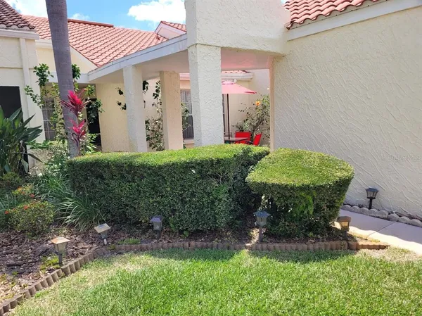 a view of a chair and table in backyard
