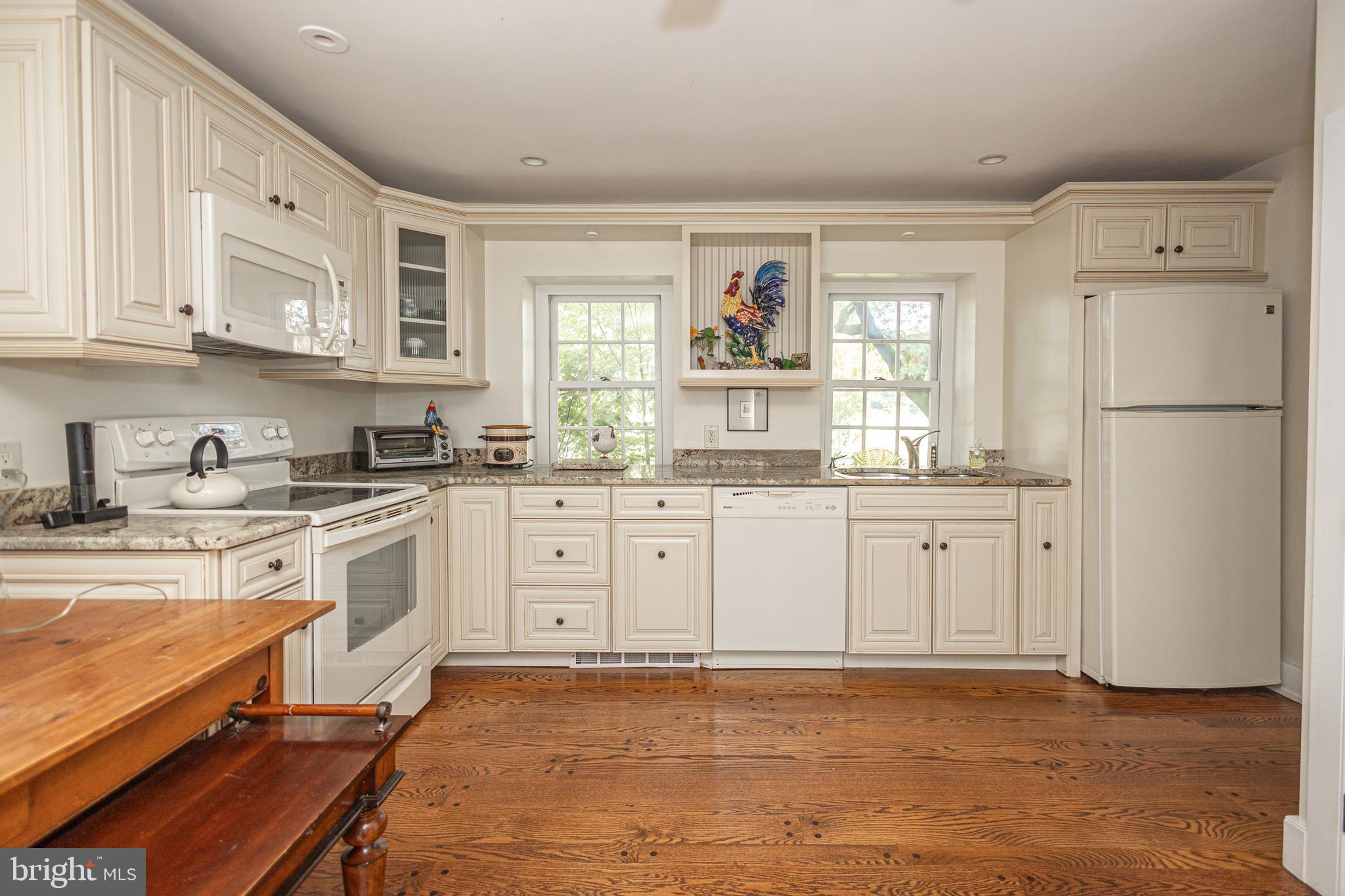 5025 Anderson Road Doylestown, PA 18902 - Photo 44 of 92 a kitchen with white cabinets and white appliances