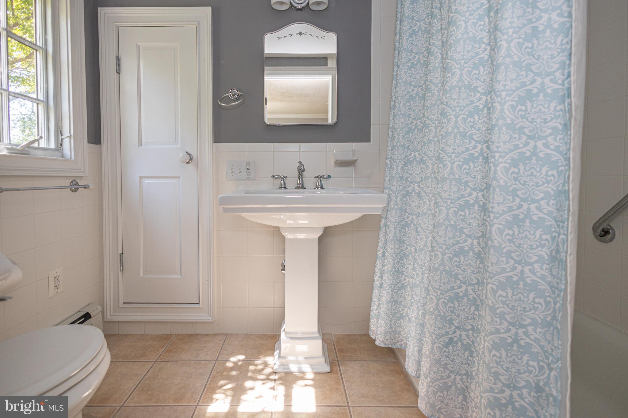5025 Anderson Road Doylestown, PA 18902 - Photo 46 of 92 a bathroom with a sink a toilet and mirror