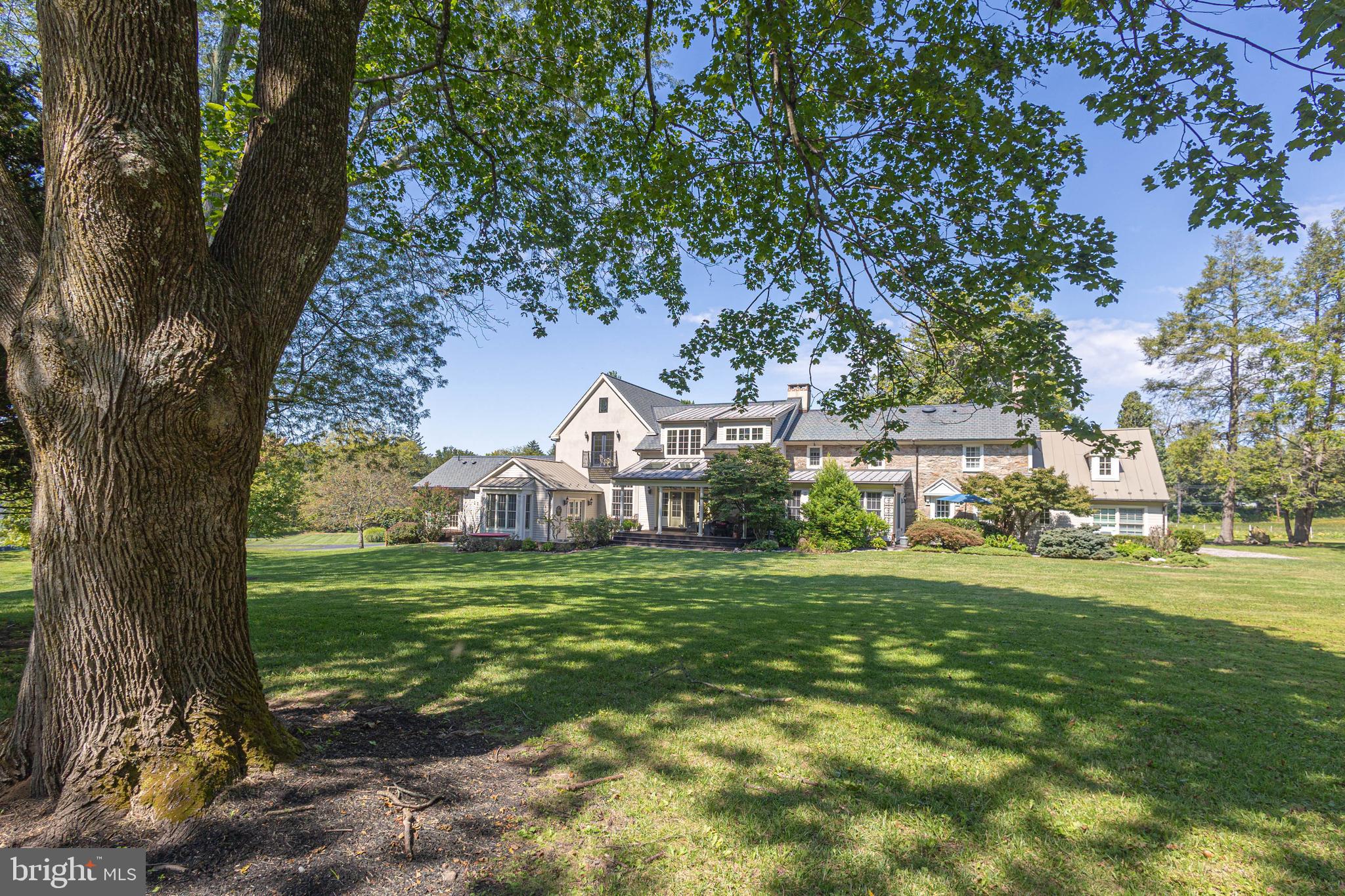 5025 Anderson Road Doylestown, PA 18902 - Photo 75 of 92 a view of a big house with a big yard and large trees