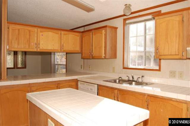 265 Aristocrat Way Reno, NV 89506 - Photo 2 of 7 a kitchen with granite countertop a sink and a window