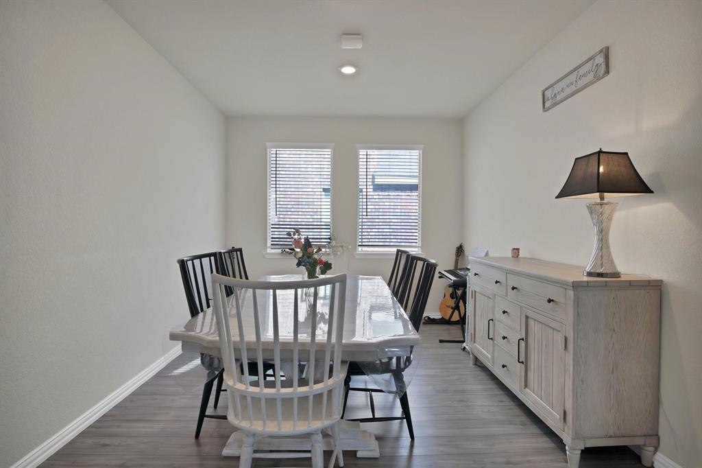 621 Ridgeback Trail Fort Worth, TX 76052 - Photo 9 of 22 Dining area with wood-finish flooring, two windows with blinds, recessed lighting, and white baseboards