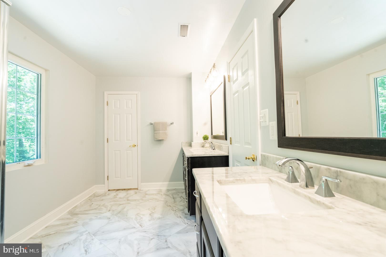 5705 Solomons Island Road St. Leonard, MD 20685 - Photo 26 of 46 a bathroom with a granite countertop sink and a mirror