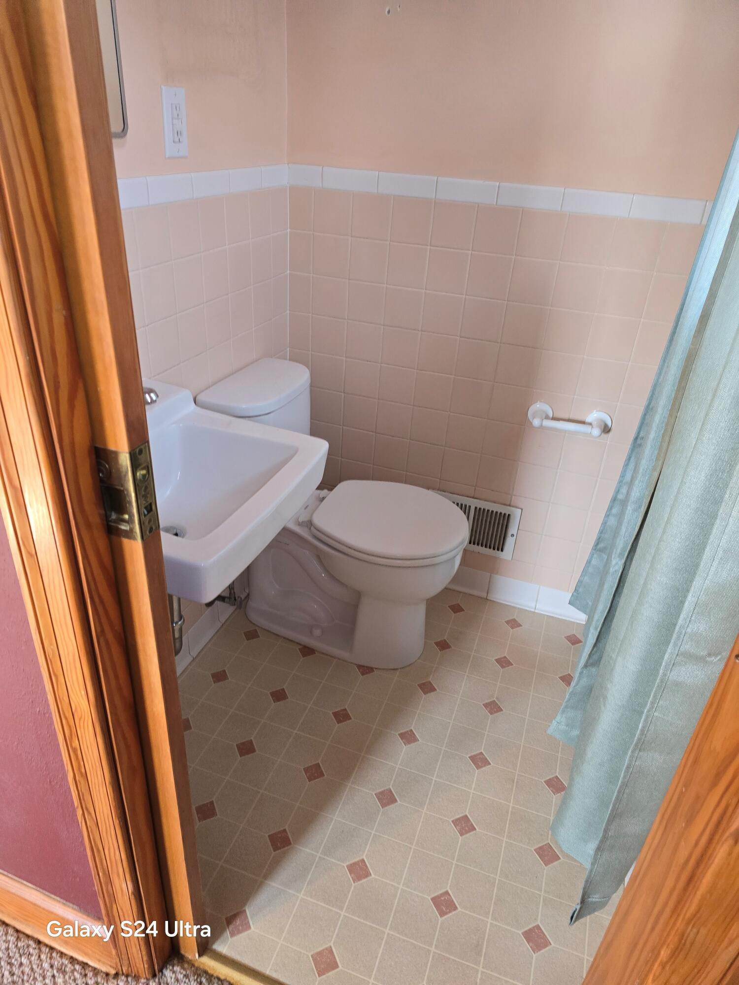 2639 Edgewood Street Southwest Roanoke, VA 24015 - Photo 11 of 12 a white toilet sitting next to a sink a small yard