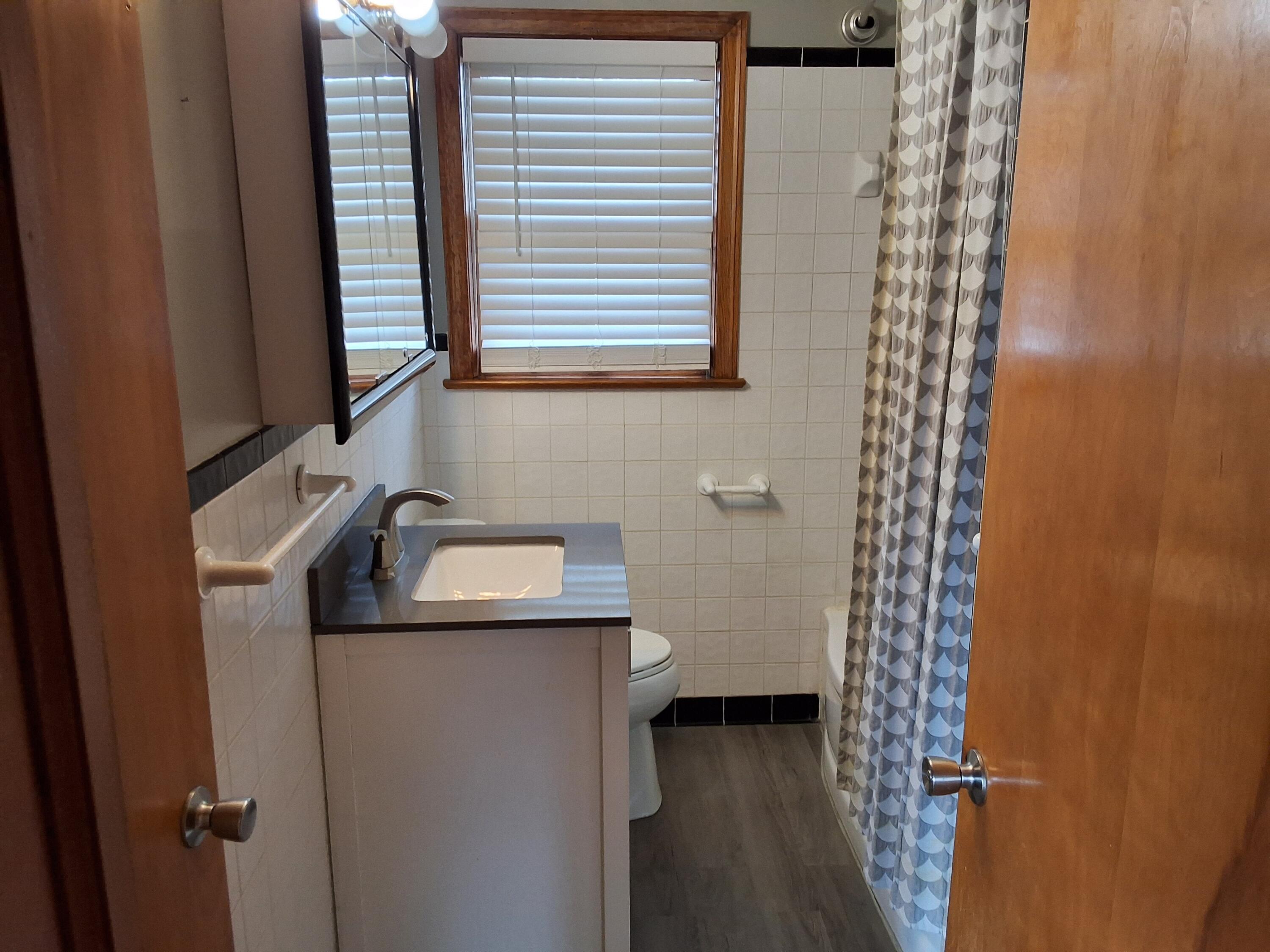 2639 Edgewood Street Southwest Roanoke, VA 24015 - Photo 3 of 12 a bathroom with a sink and a mirror