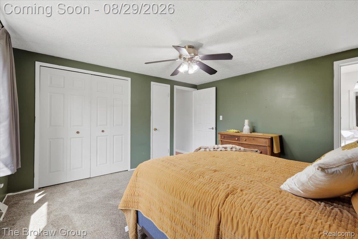 5411 Hess Road Dryden, MI 48428 - Photo 26 of 56 Textured wall-to-wall carpeting, dual bi-fold closet doors, and ceiling fan with integrated lighting