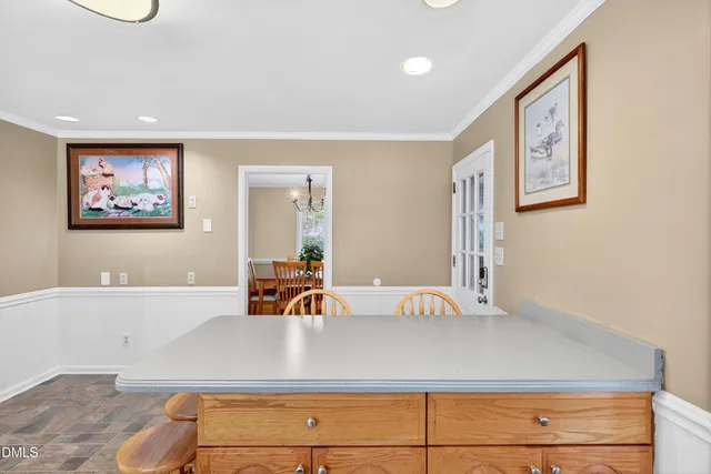 a view of a living room with a large mirror and dresser