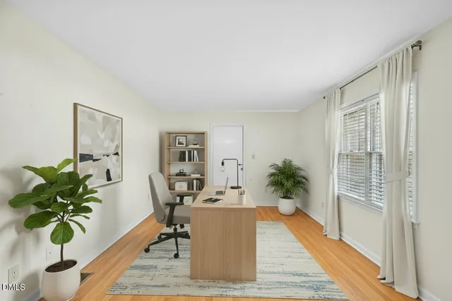 a living room with furniture potted plant and a wooden floor