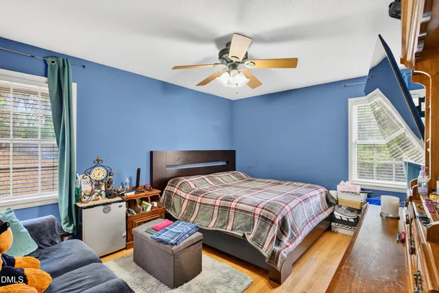 a bedroom with a bed and a chandelier