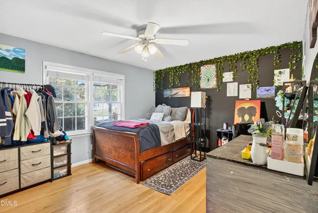 a bedroom with furniture and a flat screen tv