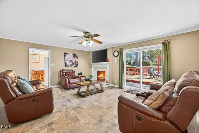 a living room with furniture large window and a fireplace